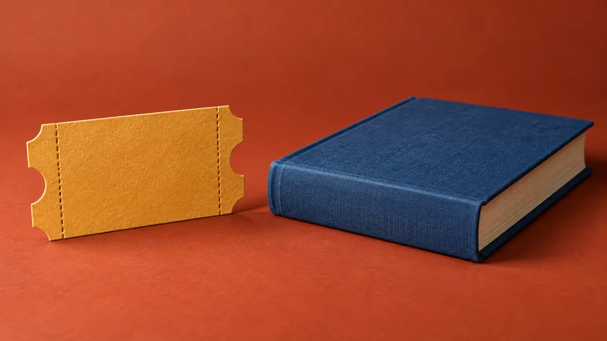 Входной билет рядом с книгой в синем переплёте